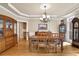 Formal dining room with hardwood floors, large windows, and elegant chandelier at 6260 Sturbridge Ln, Cumming, GA 30040