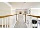 Bright hallway with carpet flooring and neutral walls leading to various rooms within the home at 6260 Sturbridge Ln, Cumming, GA 30040