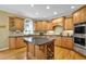 Spacious kitchen with granite countertops, custom cabinets, and a central island at 6260 Sturbridge Ln, Cumming, GA 30040