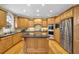 Modern kitchen featuring stainless steel appliances, a center island, and ample cabinet space at 6260 Sturbridge Ln, Cumming, GA 30040