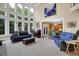 Bright living room with soaring windows, hardwood floors, and stylish, comfortable furnishings at 6260 Sturbridge Ln, Cumming, GA 30040