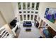 Aerial view of the living room showcasing fireplace, tall windows, and elegant decor at 6260 Sturbridge Ln, Cumming, GA 30040