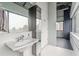 Bathroom with pedestal sink features mirror cabinet and city view through large windows at 120 Ralph Mcgill Ne Blvd # 1502, Atlanta, GA 30308