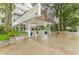 Building entrance features a covered portico, mature trees, and attractive landscaping at 120 Ralph Mcgill Ne Blvd # 1502, Atlanta, GA 30308