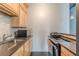 Efficient kitchen featuring wood cabinets, subway tile backsplash and black countertops at 120 Ralph Mcgill Ne Blvd # 1502, Atlanta, GA 30308