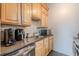Cozy kitchen with light wood cabinets, stainless steel appliances, and a stylish backsplash at 120 Ralph Mcgill Ne Blvd # 1502, Atlanta, GA 30308