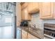 A modern kitchen with stainless steel appliances, wood cabinets and gray countertops at 120 Ralph Mcgill Ne Blvd # 1502, Atlanta, GA 30308