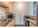 Modern kitchen featuring granite countertops, stainless steel appliances, and light wood cabinetry at 120 Ralph Mcgill Ne Blvd # 1502, Atlanta, GA 30308