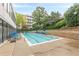 Inviting community pool surrounded by lush landscaping and comfortable lounge chairs at 120 Ralph Mcgill Ne Blvd # 1502, Atlanta, GA 30308