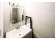 Bathroom featuring a chrome framed mirror, tile flooring, and chrome faucet at 1200 Ashborough Se Ter # A, Marietta, GA 30067