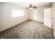 Spacious bedroom with carpeted floors, a ceiling fan, a window and a closet at 1200 Ashborough Se Ter # A, Marietta, GA 30067