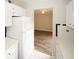 Galley kitchen featuring white cabinets and appliances and an adjacent living area at 1200 Ashborough Se Ter # A, Marietta, GA 30067