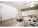 Bright kitchen featuring white appliances, tiled floors, and ample counter space at 1200 Ashborough Se Ter # A, Marietta, GA 30067