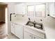 The kitchen features a stainless steel sink, white counters and cabinets, and a dishwasher at 1200 Ashborough Se Ter # A, Marietta, GA 30067