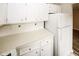 Kitchen featuring white countertops and cabinets with a white refrigerator at 1200 Ashborough Se Ter # A, Marietta, GA 30067