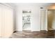 Bright living room featuring new hardwood floors and an adjacent kitchen with white appliances at 1200 Ashborough Se Ter # A, Marietta, GA 30067