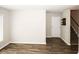 Open living area featuring modern wood-look floors, neutral paint, and stairway access at 1200 Ashborough Se Ter # A, Marietta, GA 30067