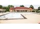 Community pool with surrounding green space and a nearby clubhouse at 1200 Ashborough Se Ter # A, Marietta, GA 30067