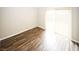 Room featuring wood-look floors and a sliding glass door with vertical blinds at 1200 Ashborough Se Ter # A, Marietta, GA 30067