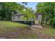 Exterior back view of house with nice yard and carport area providing shelter for parking at 243 Howell Ter, Atlanta, GA 30331