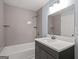 Bathroom featuring a shower-tub combo with tile surround, a modern vanity, and updated fixtures at 243 Howell Ter, Atlanta, GA 30331