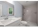 Bathroom with a stylish vanity, a framed mirror, and a modern tiled shower with sleek fixtures at 243 Howell Ter, Atlanta, GA 30331