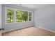 A bedroom with wood floors and a view of large, leafy trees out the window at 243 Howell Ter, Atlanta, GA 30331