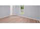 A bedroom with wood floors and one window at 243 Howell Ter, Atlanta, GA 30331
