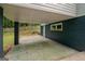 Carport featuring concrete flooring and painted cinderblock wall providing covered parking and shade at 243 Howell Ter, Atlanta, GA 30331