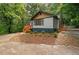 Home's exterior features a charming wooden deck, surrounded by greenery and inviting curb appeal at 243 Howell Ter, Atlanta, GA 30331