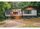Inviting home with wood deck, steps and lots of natural light, nestled in a green, leafy setting at 243 Howell Ter, Atlanta, GA 30331