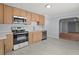 A kitchen with stainless steel appliances, and light wood cabinets at 243 Howell Ter, Atlanta, GA 30331