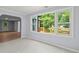 Sun-filled living room showcases a large window with views of the outdoor deck and greenery at 243 Howell Ter, Atlanta, GA 30331