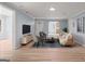 Bright living room with neutral colors, modern decor and hardwood floors creates a comfortable living space at 243 Howell Ter, Atlanta, GA 30331