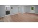 Large living room featuring hardwood floors and an open layout connects to a bathroom down the hall at 243 Howell Ter, Atlanta, GA 30331