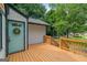 View of the lovely side deck with wood railing and a beautiful front door with a welcoming wreath at 243 Howell Ter, Atlanta, GA 30331