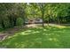 Long green front yard with trees and a house nestled in the back in a quiet community at 243 Howell Ter, Atlanta, GA 30331