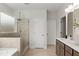 Modern bathroom with glass-enclosed shower, tile floor, and double door entry at 3443 Hillyard Dr, Dacula, GA 30019