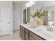 Bright bathroom features double sink vanity with modern fixtures and decor; tile flooring and white doors at 3443 Hillyard Dr, Dacula, GA 30019