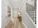 Inviting entryway featuring hardwood floors, staircase with iron railings, and modern decor at 3443 Hillyard Dr, Dacula, GA 30019