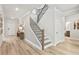 Welcoming entryway featuring hardwood floors, staircase with iron railings, and modern decor at 3443 Hillyard Dr, Dacula, GA 30019