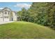 Wide shot of backyard with mature trees providing privacy and a view of the stairs to the deck at 4005 Greentree Ct, Douglasville, GA 30135