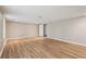 Large basement with wood-look flooring, neutral walls, and a convenient door leading to another room at 4005 Greentree Ct, Douglasville, GA 30135