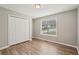 Cozy bedroom with a double closet, a large window, and contemporary flooring at 4005 Greentree Ct, Douglasville, GA 30135