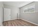 Well-lit bedroom featuring wood-look floors and a large window, creating a serene and inviting atmosphere at 4005 Greentree Ct, Douglasville, GA 30135