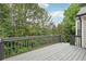 Spacious outdoor deck with gray railings, offering a serene view of the surrounding trees and greenery at 4005 Greentree Ct, Douglasville, GA 30135
