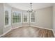 Bright dining room features hardwood floors, large windows, and a modern chandelier at 4005 Greentree Ct, Douglasville, GA 30135