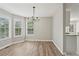 Bright dining room features hardwood floors, large windows, and a modern chandelier at 4005 Greentree Ct, Douglasville, GA 30135