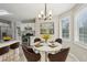 Charming dining area with modern chandelier and natural light from surrounding windows at 4005 Greentree Ct, Douglasville, GA 30135