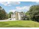 Exterior view showing the side of the house with three-car garage and backyard at 4005 Greentree Ct, Douglasville, GA 30135